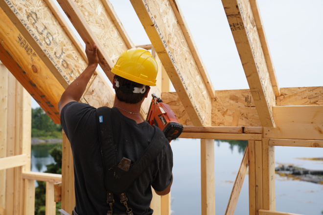 Carpenter working on house