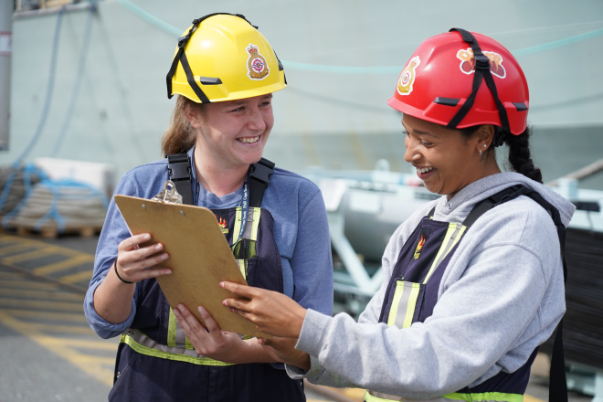 Apprentices looking at chart together.